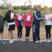 Val Woler and Louise Ramsey flank the 365 Athletes group as they receive their certificates from Graeme Ballard
